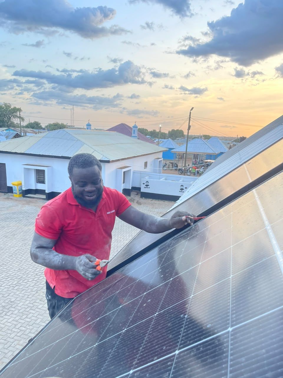 Technician working with a rooftop solar panel
