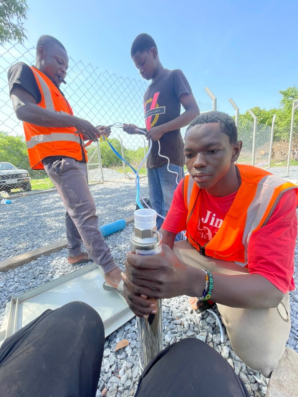 Technicians handling solar pumping equipment